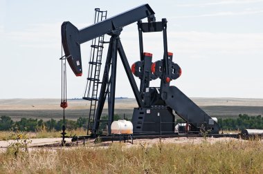 Pump jack lifting crude oil clipart