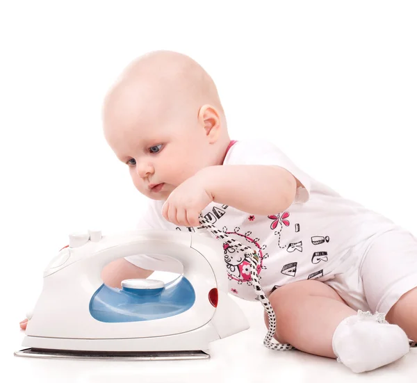 Cute baby playing with iron — Stock Photo, Image