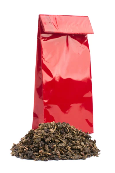 Heap of black tea and tea package — Stock Photo, Image