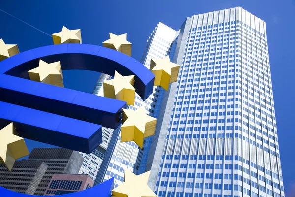 Euro signo y ciudad — Foto de Stock