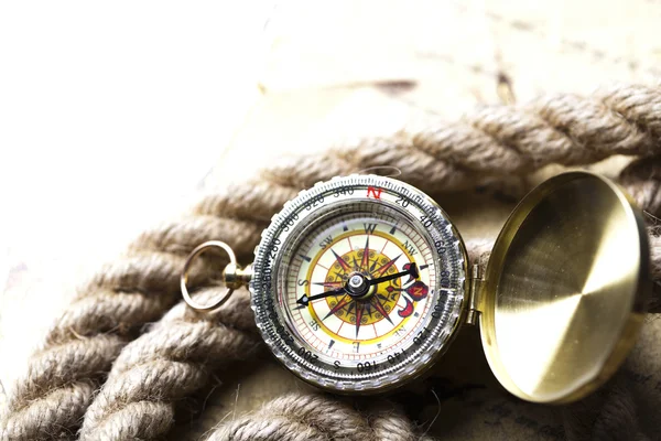 Antique brass compass over old map — Stock Photo, Image