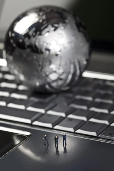 Laptop with figure over chrome background — Stock Photo, Image