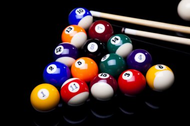 Billiard balls, cue on black table clipart