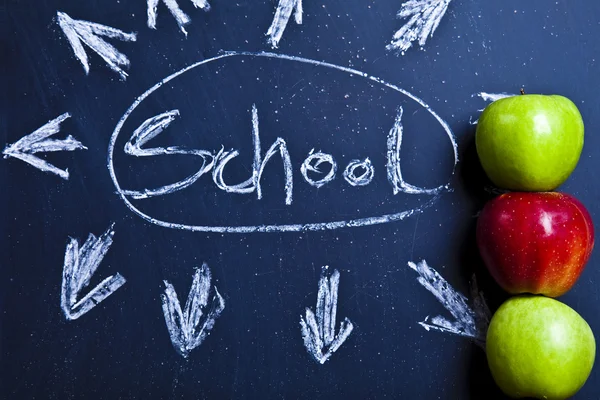 Apple on a chalkboard, healthy breakfast at school — Stock Photo, Image