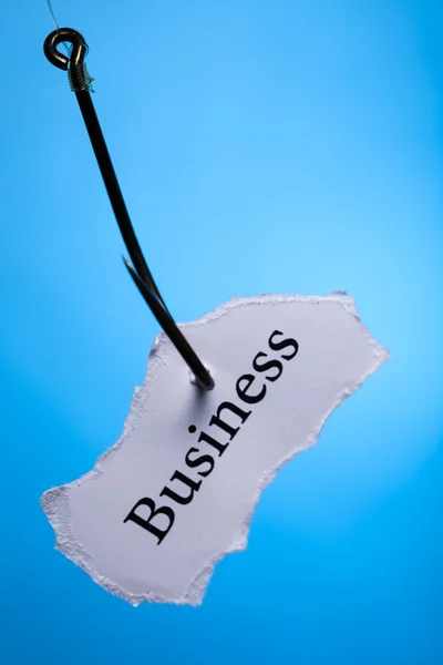 Business on peace of paper pierced in hook — Stock Photo, Image