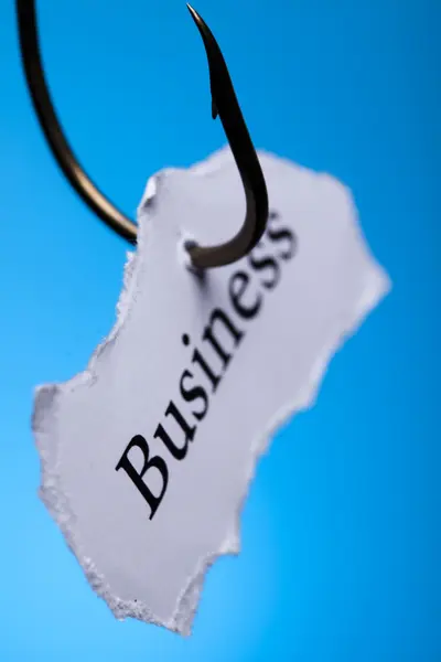 Business on peace of paper pierced in hook — Stock Photo, Image