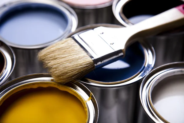 Cans of paint with paintbrush Stock Image