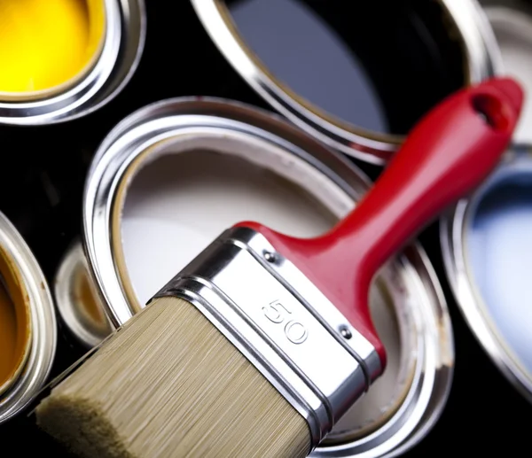Cans of paint with paintbrush Stock Image