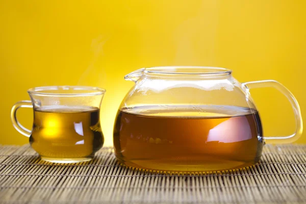 Glass teapot with green tea — Stock Photo, Image