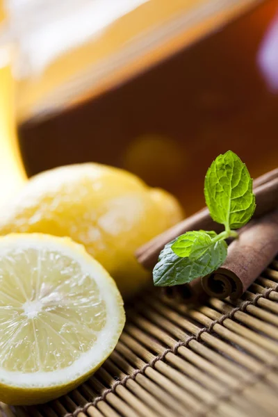 stock image Glass teapot of tea with lemon