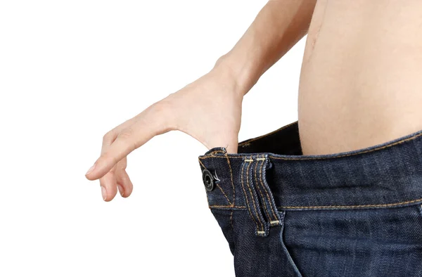Štíhlá žena ve velkých džíny — Stock fotografie