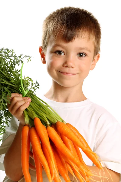 Boy with carrots — Stock Photo, Image