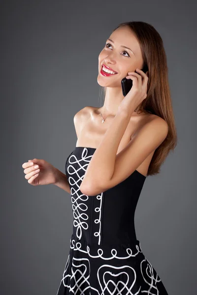 Young woman with mobile phone in studio — Stock Photo, Image