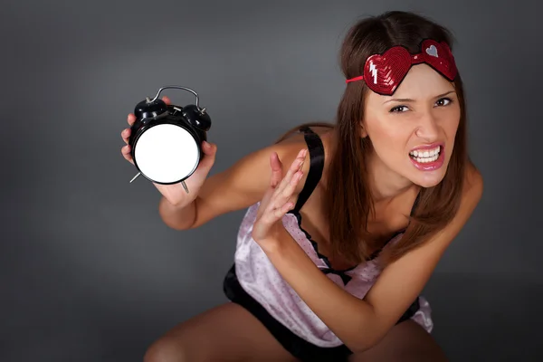 Angry woman with alarm clock — Stock Photo, Image
