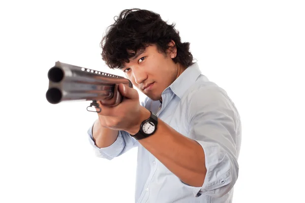 Joven asiático hombre celebración pistola — Foto de Stock