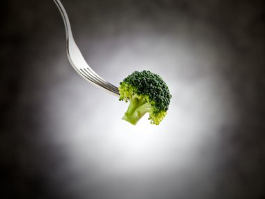 Fork is holding broccoli clipart