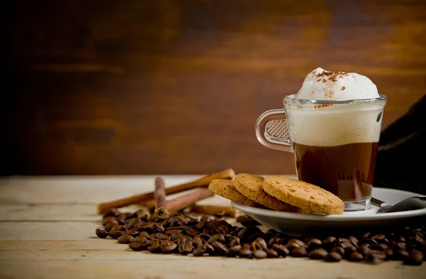 Cappuccino on coffee beans — Stock Photo, Image