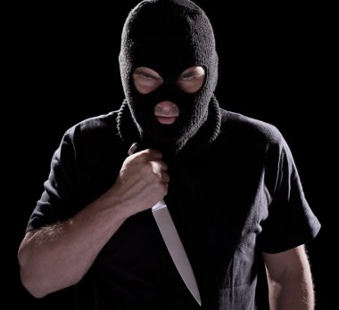 Burglar in mask holding knife clipart