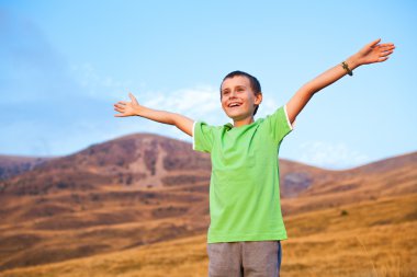 Portrait of a boy on mountains clipart