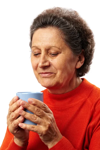 Old woman drinking from a cup — Stock Photo, Image