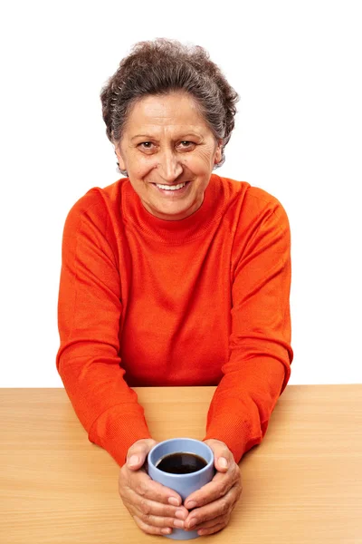 Old woman drinking from a cup — Stock Photo, Image