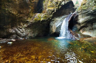 Waterfall in mountains clipart