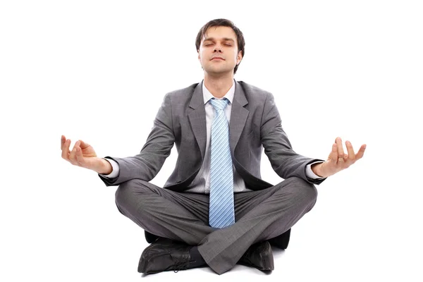 Young businessman meditating — Stock Photo, Image