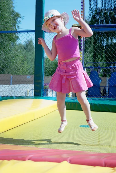 stock image The little girl on a trampoline in park