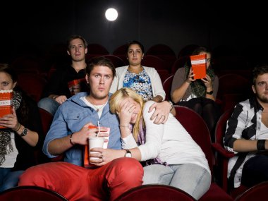 Young couple at cinema clipart