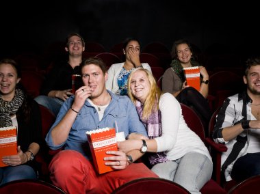 Young couple at cinema clipart