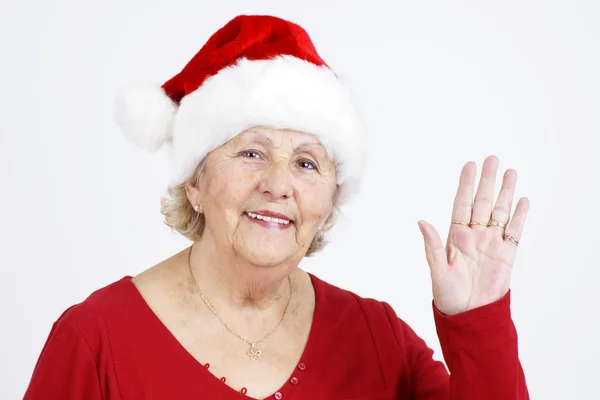 クリスマス帽子のおばあちゃんを振ってこんにちは — ストック写真