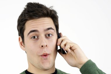 Surprised young man on cell phone clipart