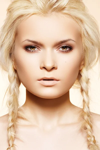 Beautiful blond woman with fashion hairstyle with pigtail — Stock Photo, Image