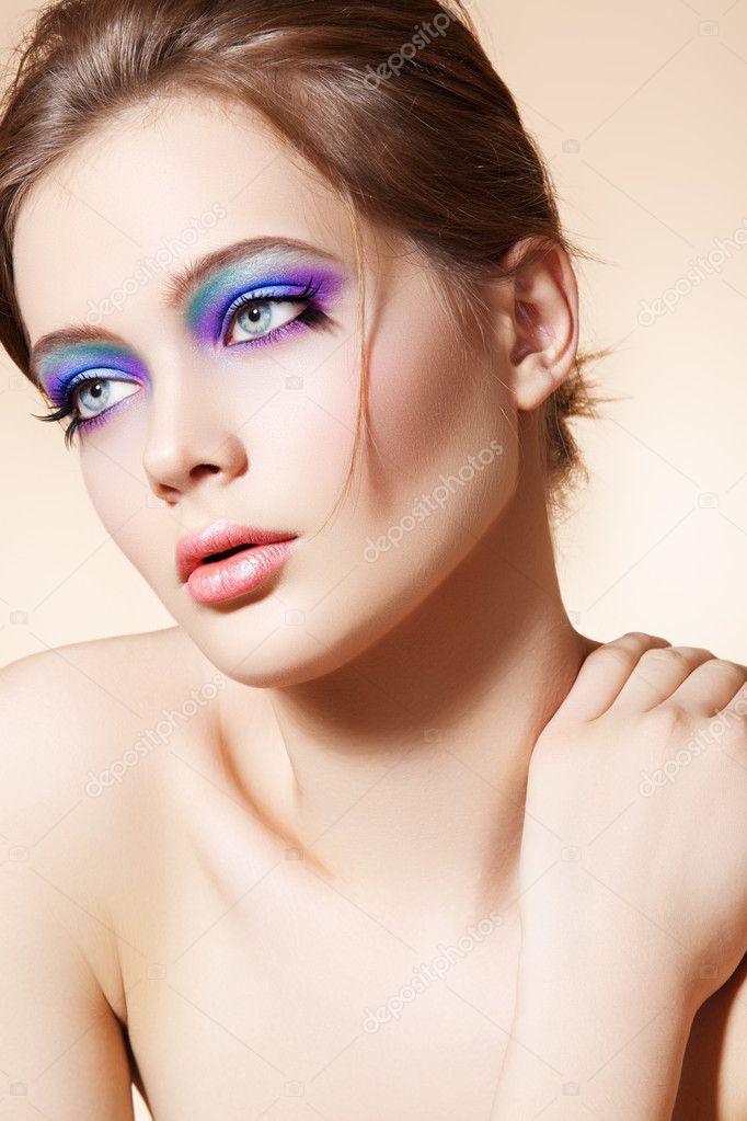 Beautiful woman model with bright fashion make-up, simple hairstyle