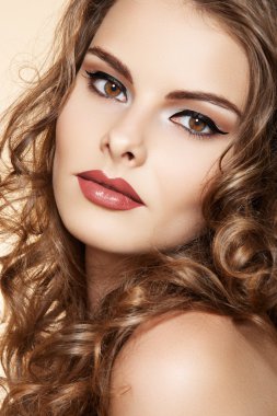 Beautiful woman with fashion make-up and shiny curly hair clipart