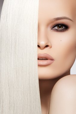 Sensual woman model with shiny straight long blond hair clipart