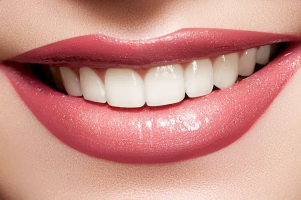 Close-up šťastné ženy úsměv s zdravé zuby bílé, světlé lesklé rty — Stock fotografie