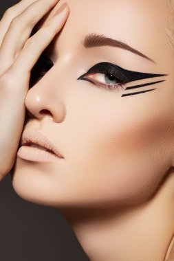 Stock Photo: Glamourous closeup female portrait. Fashion eyeliner make-up clipart