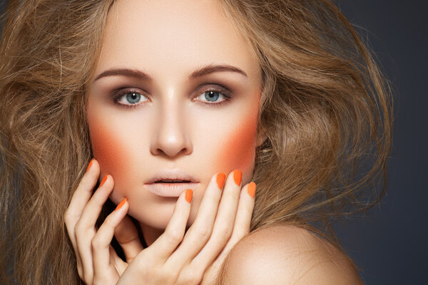 High fashion look. Woman model with fashionable makeup, bright orange blush