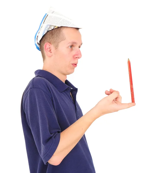Jovem trabalhador balanceando lápis em seu dedo — Fotografia de Stock