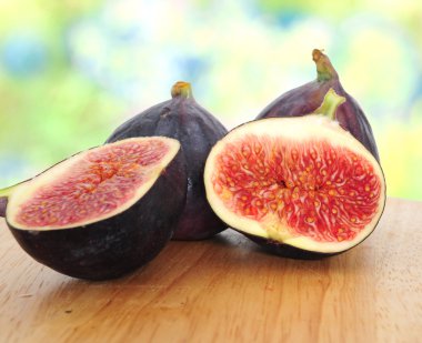 Fresh figs on wooden board clipart