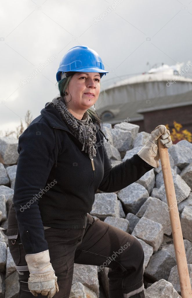 Female manual worker in blue hard hat