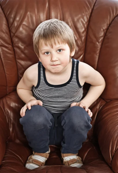 Blond boy in armchair — Stock Photo, Image