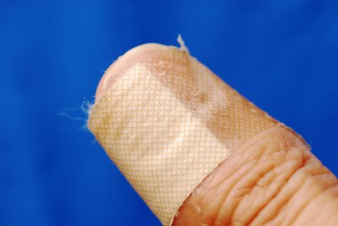 Adhesive bandage on the thumb concept of injury and first aid clipart