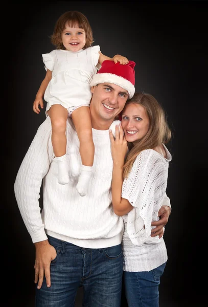 Father in santa hat holding little girl on his shoulder and hugg — Stock Photo, Image