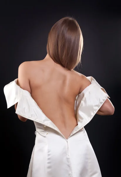 Pretty girl with bare back in the studio — Stockfoto