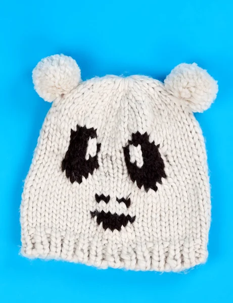 Knitted wool hat with a pattern of little faces — Stock Photo, Image