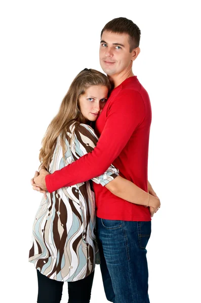 Menina abraçando um cara em um vestido vermelho no estúdio — Fotografia de Stock