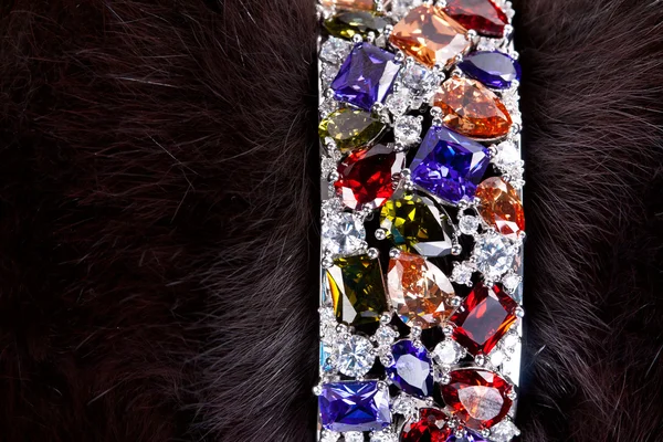 Bracelet with precious stones in a dark fur — 图库照片