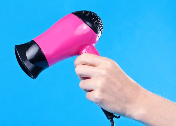Pink hair dryer in the female hand — Stock Photo, Image
